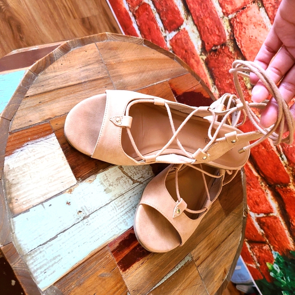 Blush pink ballet flats with ankle wrap laces
